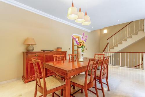 a dining room with a wooden table and chairs at Villa Teide in La Orotava