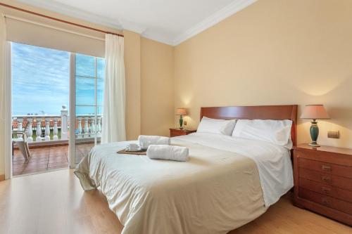a bedroom with a large bed and a balcony at Villa Teide in La Orotava