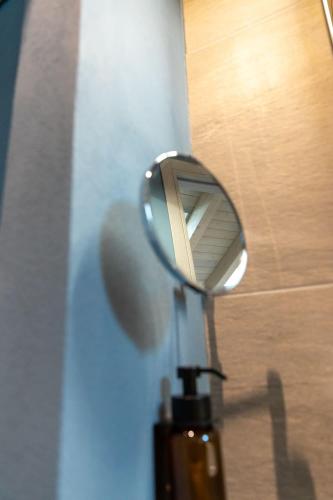 a mirror on the side of a door at Palais Bernadette in Parma