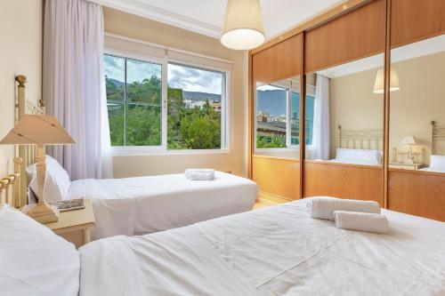 a hotel room with two beds and a window at Villa Teide in La Orotava