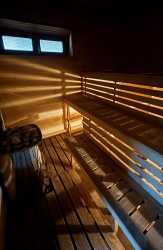 a empty bench in a room with a window at Jaunsētas in Alūksne