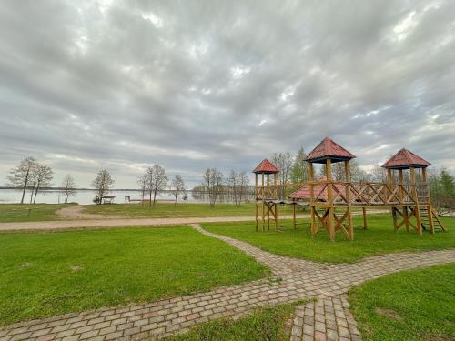 a playground with two gazebos in a park at Jaunsētas in Alūksne