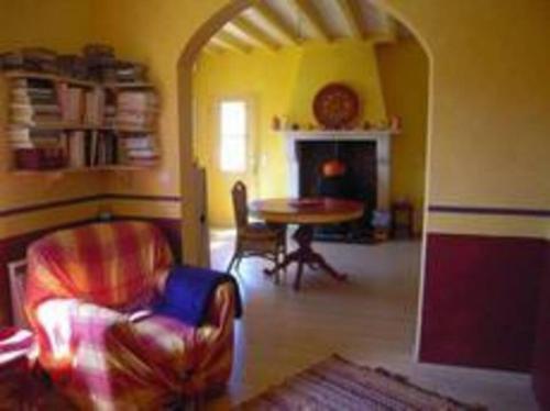 un salon avec une table et des chaises et une cheminée dans l'établissement Maison de Charme Herm, à Herm