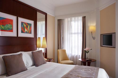 a hotel room with a bed and a window at Hotel Royal Macau in Macau