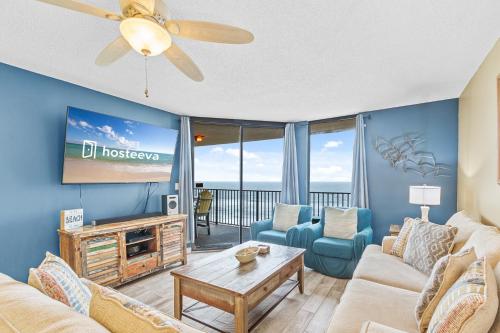a living room with a couch and a tv at Phoenix V Unit 816 in Orange Beach
