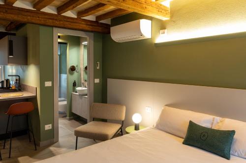 a bedroom with a bed and a kitchen and a bathroom at Palais Bernadette in Parma