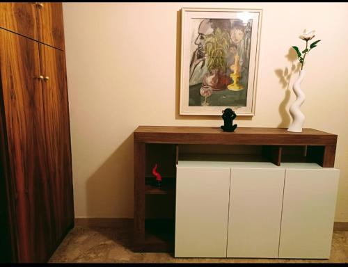 a living room with a cabinet and a picture on the wall at casa vacanze relais in Fara San Martino