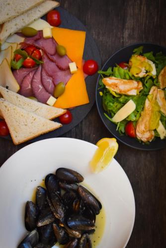 a table with two plates of food and a salad at JR Piran B&B in Piran