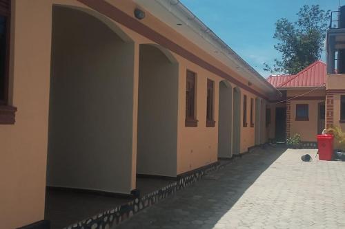 a row of buildings with a walkway at Home Waka in Wakiso