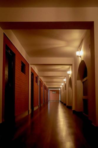 an empty hallway with lights on the walls of a building at Mountain Vista Retreat in Nagarkot