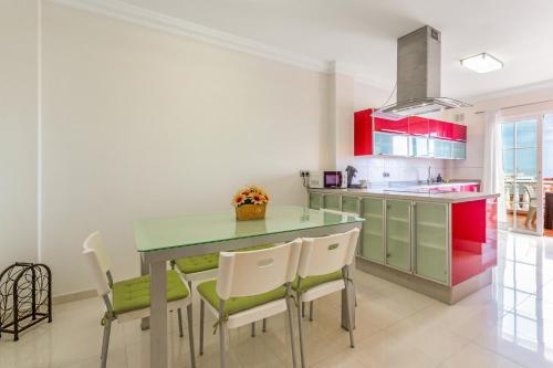 a kitchen with a green table and chairs at Villa Teide in La Orotava