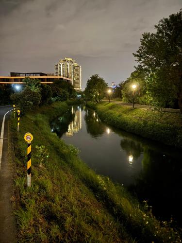 a river at night with a building in the background at 碧雲香榭羅東包棟民宿 in Luodong