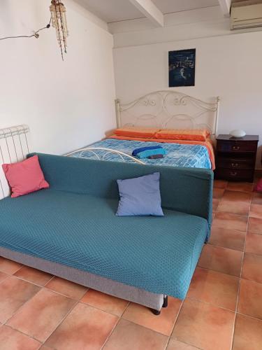 a bed and a couch in a room at Villa Alma in Bari