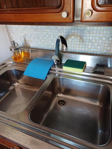 a kitchen sink with two notebooks sitting on it at Villa Alma in Bari