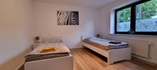 Ένα ή περισσότερα κρεβάτια σε δωμάτιο στο TAKAppartement Dormagen