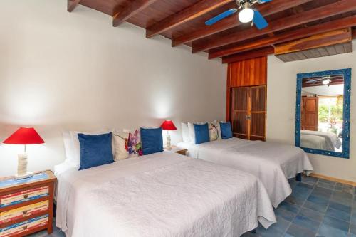 a bedroom with two beds and a window at Restful Casa Quetzal Luxurious Rainforest Retreat in Quepos