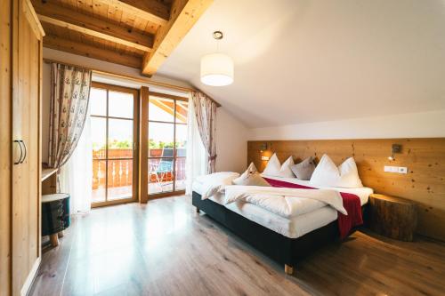 a bedroom with two beds and a large window at Residenz Erschbaum in Valdaora