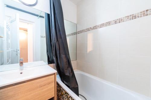 a bathroom with a sink and a tub and a shower at Le Corbier - studio avec belle vue montagne in Villarembert