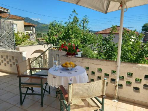a table with a bowl of fruit on a balcony at traditional village house in Ariokhórion