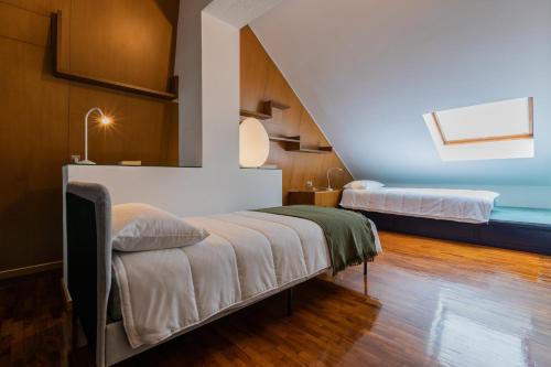 a room with two beds and a staircase at Villetta con Giardino allo Stadio by Wonderful Italy in Turin