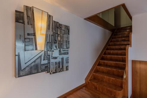 a staircase with a painting on the wall next to a stair case at Villetta con Giardino allo Stadio by Wonderful Italy in Turin