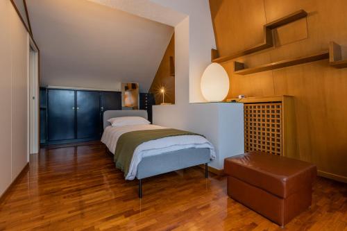 a bedroom with a bed and a wooden floor at Villetta con Giardino allo Stadio by Wonderful Italy in Turin