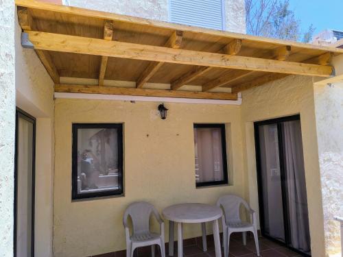a patio with a table and chairs on a house at Ryaproperty in Morro del Jable
