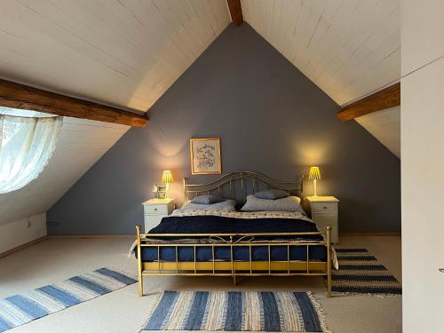 a bedroom with a bed in a attic at Forsthartl 7 Landhausurlaub in Steinbach