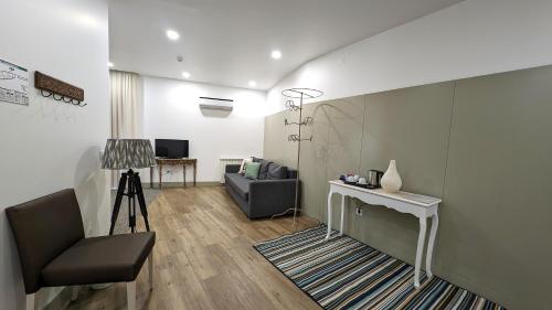 a living room with a chair and a table at Quinta do Burgo - Nature Hotel in Amares