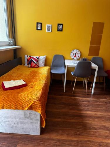 a bedroom with a bed and a table and chairs at Travel House Wroclaw in Wrocław