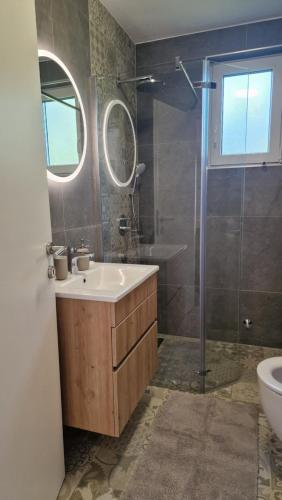 a bathroom with a sink and a shower at Miljana in Vukovar