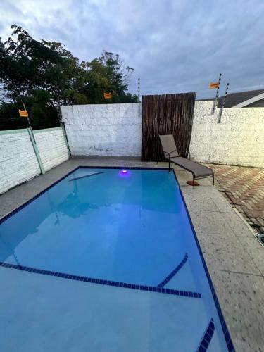 a large swimming pool with a chair next to it at The legacy BnB in East London