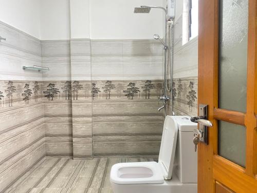 a bathroom with a toilet and a shower at La Maison Yala in Tissamaharama