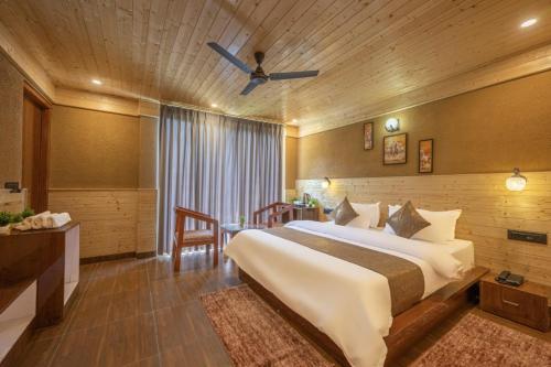 a bedroom with a large bed in a room at The Countryside Retreat I Vacations I Conference I MICE I Family Events I Open Air Terrace I Sky Bonfire I Kufri by Exotic Stays in Shimla