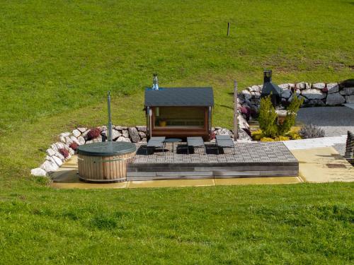 a fireplace in a field with a fire pit at Casera Cornolera in Chies dʼAlpago