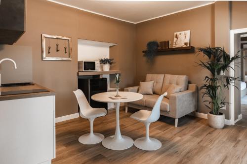 a living room with a table and a couch at Villa Antica Colonia SPA & Wellness in Pettenasco