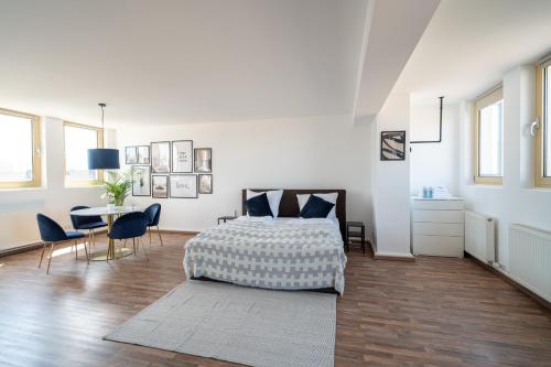 a bedroom with a bed and a table and chairs at Penthouse Panoramablick Whirlpool Parken in Koblenz
