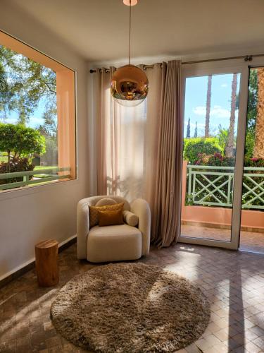a living room with a chair and a large window at Oxygène in Marrakech