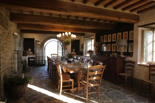 a dining room with a wooden table and chairs at Podere Cavalbianco in Ciggiano