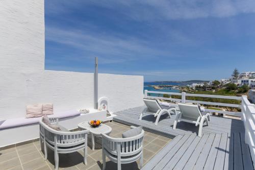 a patio with chairs and a table on a deck at Alexandros Apartments in Naousa