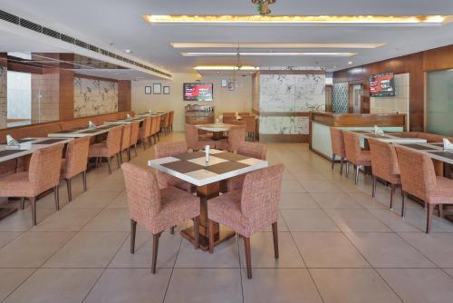 a large dining room with tables and chairs at Hotel Cama in Chandīgarh