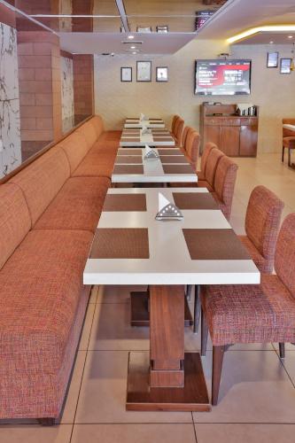 a large conference room with a long table with chairs at Hotel Cama in Chandīgarh