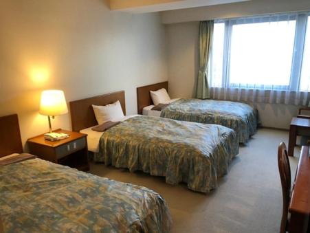 Postel nebo postele na pokoji v ubytování Sky Hotel