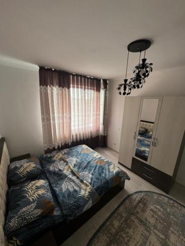 a bedroom with a bed and a chandelier at Comfort Turkestan in Türkistan