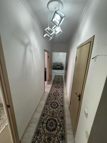 a hallway with a rug on the floor and a ceiling at Comfort Turkestan in Türkistan