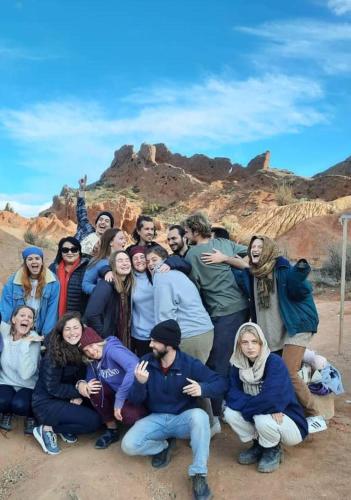 a group of people posing for a picture in the desert at Ethnocomplex Aikol in Tong
