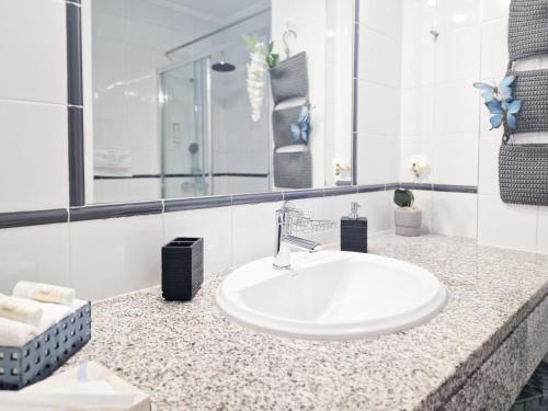 a bathroom counter with a sink and a mirror at Apartment Rocha Varandas Sunny in Portimão