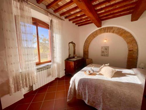 a bedroom with a bed and a large window at Il Canneto Di Pomaia in Pomaia
