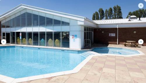 a large swimming pool in front of a building at Seaview Caravan 2 Bedroom Sleeps 6 -WiFi -Smart Tv in Colchester