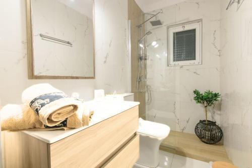 a bathroom with a sink and a shower and a toilet at Contessina House in Zakynthos